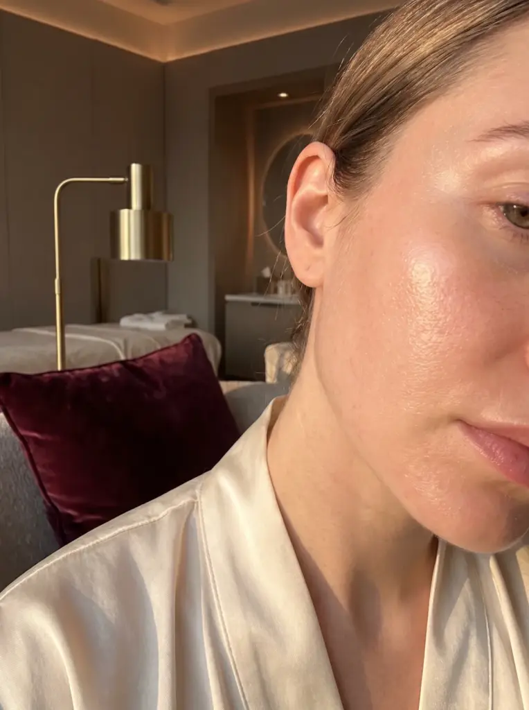 Close-up of healthy, radiant skin texture on a cheek in soft golden light