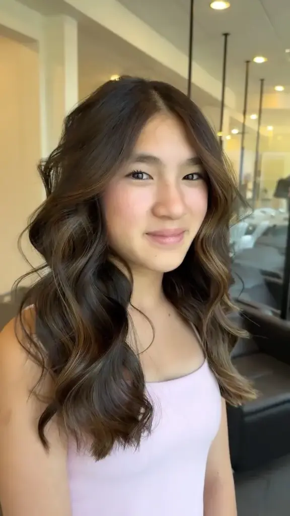 Long brunette hair styled in loose waves