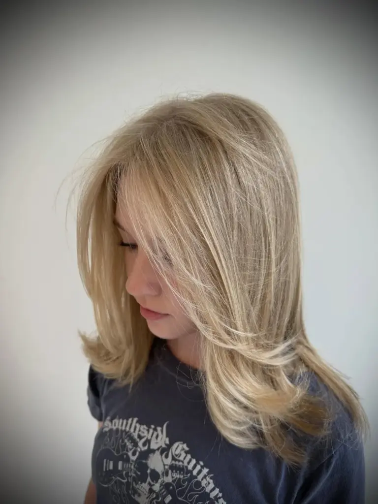 Long, smooth blonde layers with face-framing pieces
