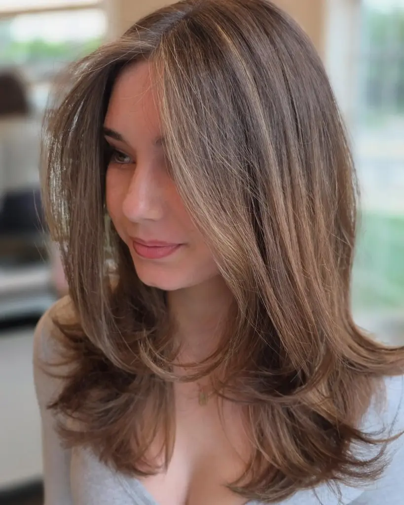 A long layered brunette cut with face-framing layers