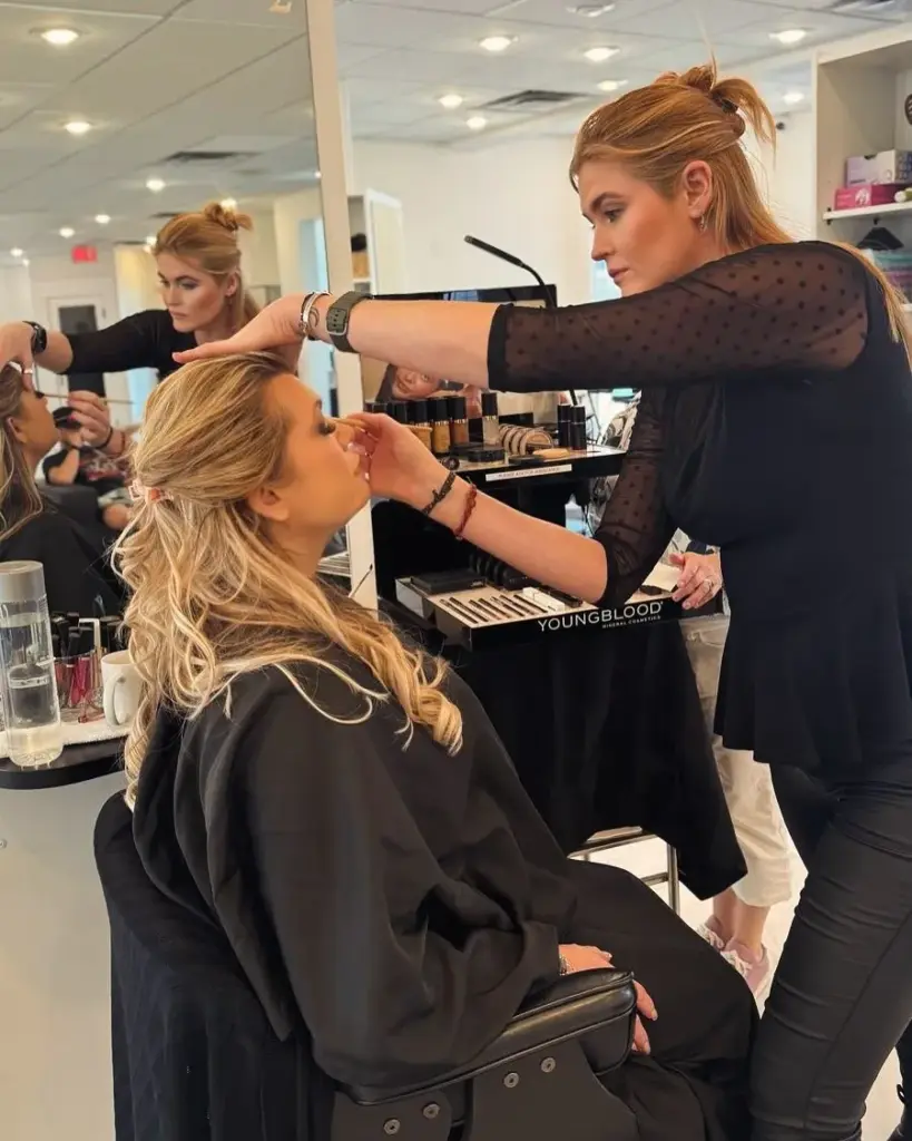 A makeup artist doing a client's makeup in the salon