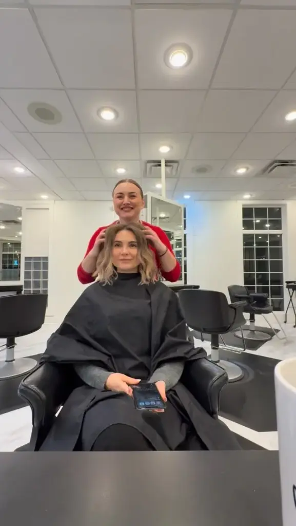 A stylist with a client after fresh blonde highlights