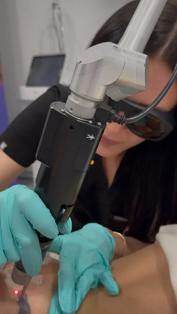 A laser skin treatment, the esthetician wearing safety glasses